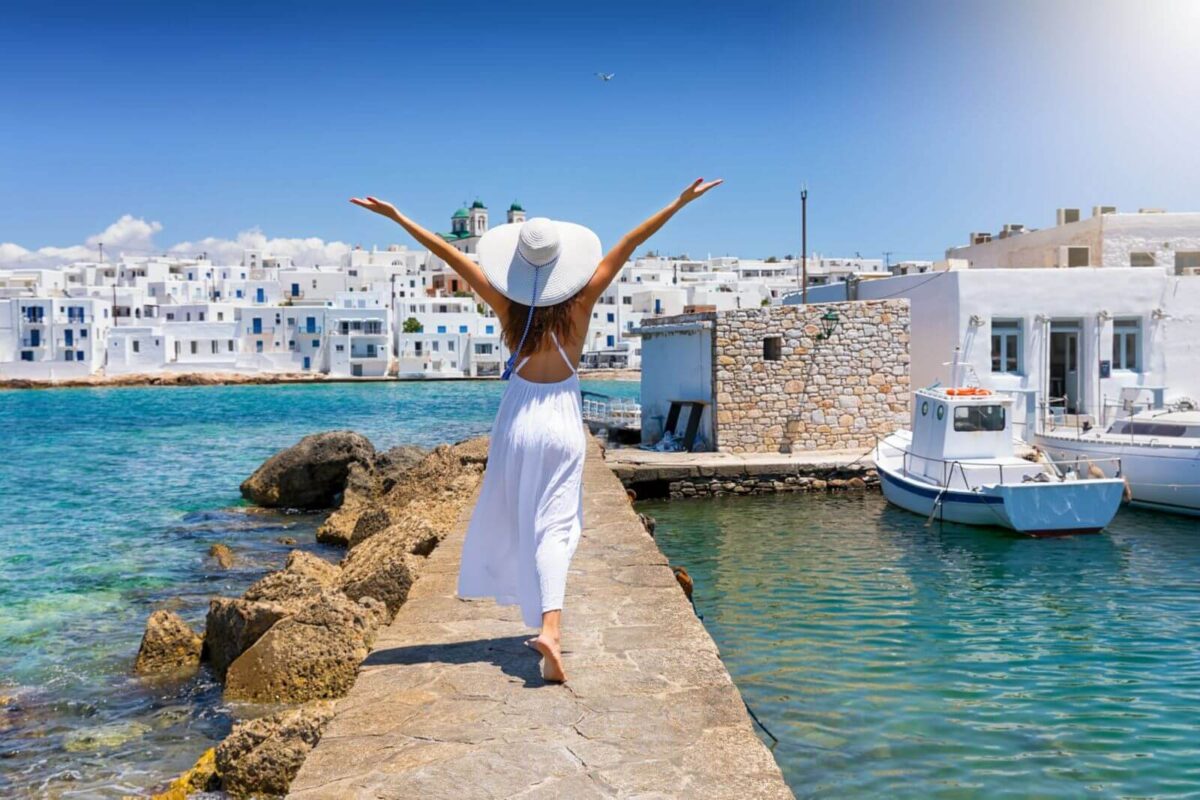 A woman exploring the village of Naoussa using the Paros ultimate travel guide