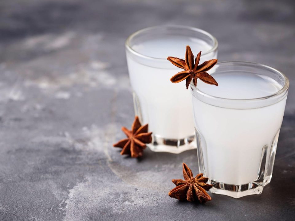 Two glasses of ouzo with three decorative anise starts, one of Chios unique products.